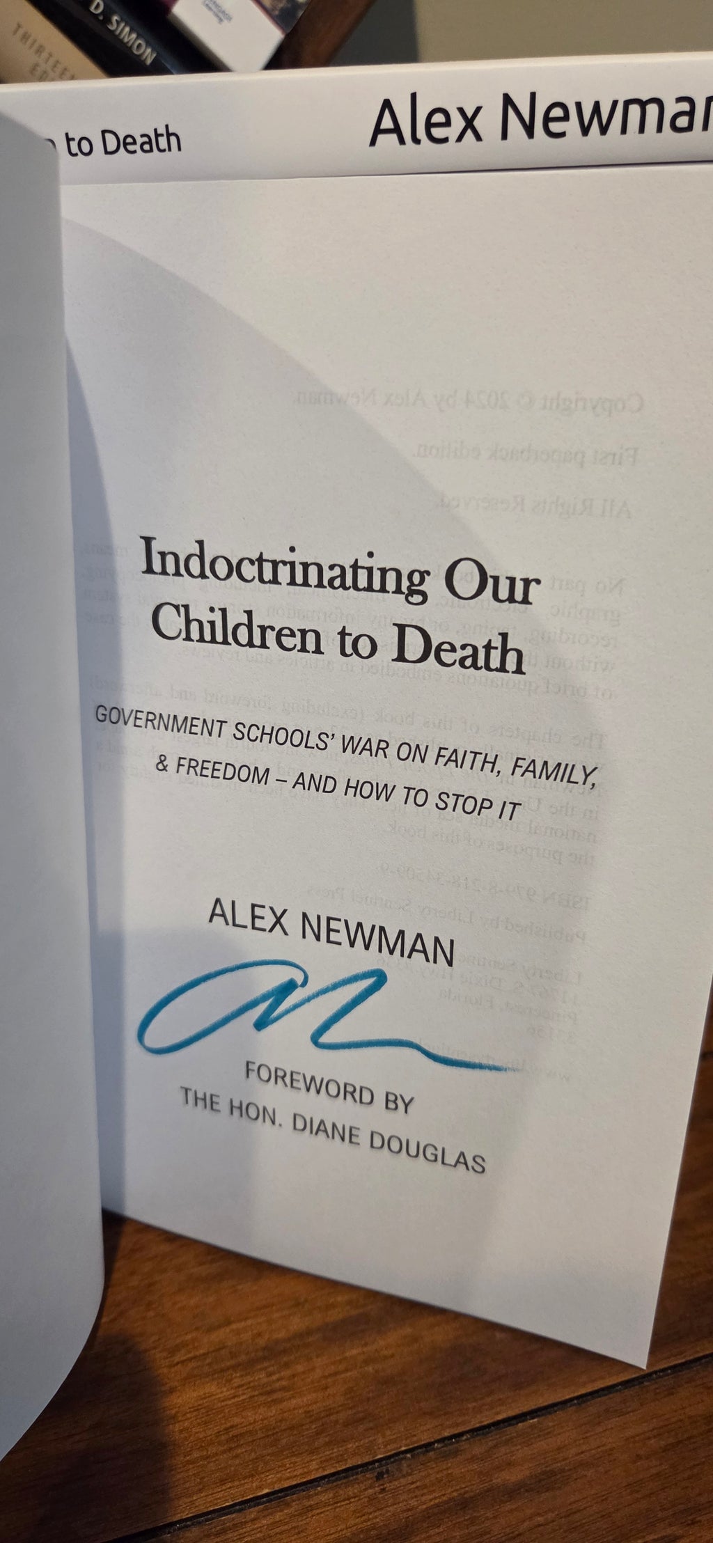 Indoctrinating Our Children to Death: Government Schools’ War on Faith, Family, & Freedom – And How to Stop It: Book signed by Alex